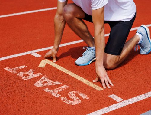 athlete at starting line readies for sprint, focusing on race and have fast decision making
